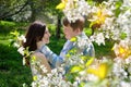 Young couple in love walking in the blossoming spring garden Royalty Free Stock Photo