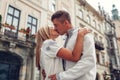 Young couple in love walking in old Lviv city wearing traditional ukrainian shirts. Man and woman hug and kiss Royalty Free Stock Photo