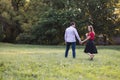 Young couple in love walking in the park, holding hands Royalty Free Stock Photo