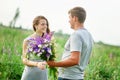 Young couple in love walking on the summer meadow Royalty Free Stock Photo