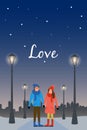 Young couple in love walks in the evening in the park along the alley with street lights, lanterns. People outdoors activity and Royalty Free Stock Photo