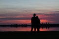 Young couple in love watching the sunset together Royalty Free Stock Photo