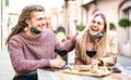 Young couple in love wearing open face mask having fun at wine bar outside - Happy modern lovers spending lunch together Royalty Free Stock Photo