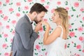 young couple in love Wedding Bride and groom kissing hand on roses backdrop. Newlyweds. Closeup portrait of a beautiful having a Royalty Free Stock Photo