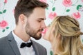 young couple in love Wedding Bride and groom kissing on roses backdrop. Newlyweds. Closeup portrait of a beautiful having a Royalty Free Stock Photo