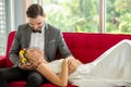 young couple in love Wedding Bride and groom lying down on red sofa together looking at each other . Newlyweds . Closeup portrait Royalty Free Stock Photo