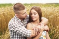 Young couple in love in a wheat field. Man and girl hugging in nature Royalty Free Stock Photo