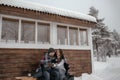 Young couple in love in the woods basking under a blanket. They drink tea from a thermos Royalty Free Stock Photo