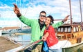 Young couple of lover taking selfie at sailboat docks on tour around world - Love concept with happy boyfriend and girlfriend