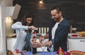 Young couple of lovers celebrating at home drinking wine Royalty Free Stock Photo