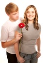 Young couple of lovers. Man presents flower. Valentine day Royalty Free Stock Photo