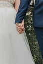 A young couple of lovers who have just got married are holding hands
