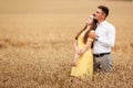 A young couple of lovers woman and man hugging in nature, in a yellow wheat field. The concept of love, good relationships, Royalty Free Stock Photo