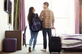 Young couple with luggage in hotel room Royalty Free Stock Photo