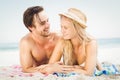 Young couple lying on the beach and talking to each other Royalty Free Stock Photo
