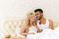 Young Couple Lying In Bed Eat Breakfast Morning With Red Rose Flower, Happy Smile Hispanic Man And Woman Royalty Free Stock Photo