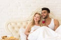 Young Couple Lying In Bed Eat Breakfast Morning With Red Rose Flower, Happy Smile Hispanic Man And Woman Royalty Free Stock Photo