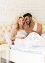 Young Couple Lying In Bed Eat Breakfast Morning With Red Rose Flower, Happy Smile Hispanic Man And Woman Royalty Free Stock Photo