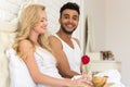 Young Couple Lying In Bed Eat Breakfast Morning With Red Rose Flower, Happy Smile Hispanic Man And Woman Royalty Free Stock Photo