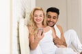 Young Couple Lying In Bed, Happy Smile Hispanic Man And Woman Using Cell Smart Phone Royalty Free Stock Photo