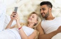 Young Couple Lying In Bed, Happy Smile Hispanic Man And Woman Using Cell Smart Phone Royalty Free Stock Photo