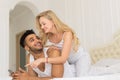 Young Couple Lying In Bed, Happy Smile Hispanic Man And Woman Using Cell Smart Phone Royalty Free Stock Photo
