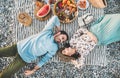 Young couple lying on blanket at picnic at sunset Royalty Free Stock Photo