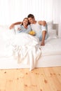 Young couple lying down in white bed Royalty Free Stock Photo