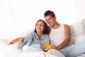 Young couple lying down in white bed Royalty Free Stock Photo