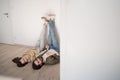 Young couple lying on floor and moving in new flat, looking at camera.