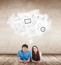 Young couple lying on the floor among painted furniture on the wall. Royalty Free Stock Photo