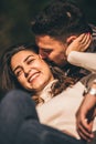 Young couple lying in the park and looking in love