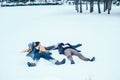 Young couple lying together in snow