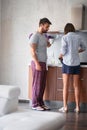 Young couple making breakfast, drinking coffee in modern kitchen. lifestyle, modern, casual, living concept