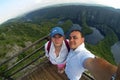 Young couple making selfie photo on the view point. Top of the hill and panorama of Canyon Uvac in Serbia