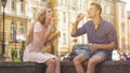 Young couple making soap bubbles, playful romantic mood on date, freedom