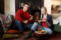 Young couple making toast on open fire Royalty Free Stock Photo
