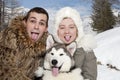 Young couple with a malamute puppy Royalty Free Stock Photo