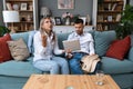 Young couple man and woman argue about overspending money on online shopping, gambling, food delivery. Husband and wife, holding Royalty Free Stock Photo