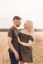 A young couple, a man and a woman look at each other with love in the summer in nature Royalty Free Stock Photo