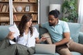 Young couple man and woman, roommates sitting at home on sofa having issue with financial debt, overspending and earnings, cant Royalty Free Stock Photo