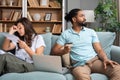 Young couple man and woman, roommates sitting at home on sofa having issue with financial debt, overspending and earnings, cant