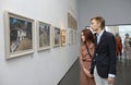 Young couple man woman visitors looking at the painting of famous Ukrainian painter Ivan Marchuk during opening his
