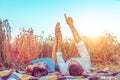 A young couple, man woman, in wheat field summer, lie on rug. Hand gestures indicate stars. Concept love, date, emotion Royalty Free Stock Photo