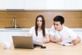 Young couple managing finances, reviewing their bank accounts using laptop Royalty Free Stock Photo