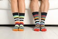 Young couple in matching socks on couch indoors