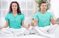 Young couple meditating together in their bedroom Royalty Free Stock Photo