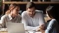 Young couple meeting with relator in cafe Royalty Free Stock Photo