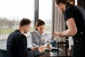 Young couple with menu in a restaurant making order Royalty Free Stock Photo