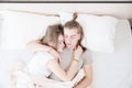 A young couple of modern men and women sleep in their white bed in a hug. the concept of a young modern family and sleep Royalty Free Stock Photo